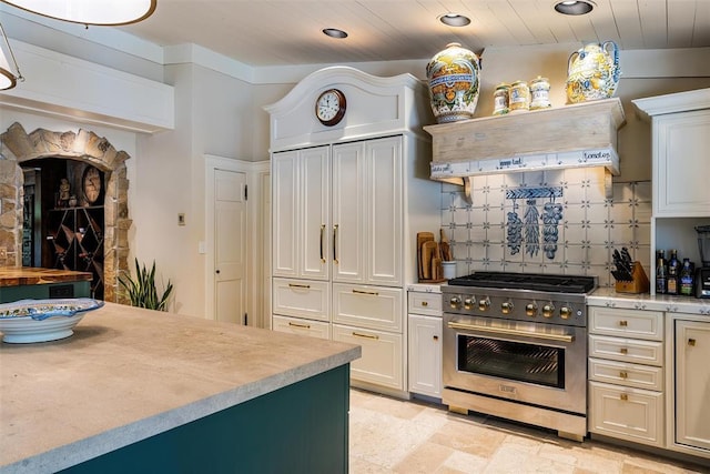 6638 Avondale Dr, Nichols Hills, OK 73116 - kitchen with high end stove, light countertops, tasteful backsplash, stone tile floors, and wooden ceiling