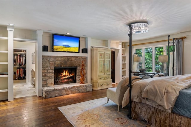 6638 Avondale Dr, Nichols Hills, OK 73116 - bedroom featuring wood finished floors, a fireplace, recessed lighting, and a spacious closet