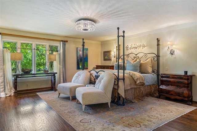 6638 Avondale Dr, Nichols Hills, OK 73116 - bedroom featuring wood finished floors and a chandelier