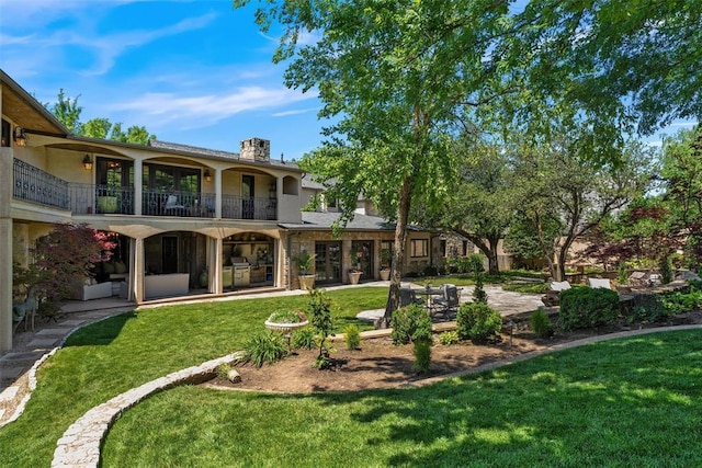 6638 Avondale Dr, Nichols Hills, OK 73116 - back of house with a balcony, a patio area, a lawn, a chimney, and stone siding