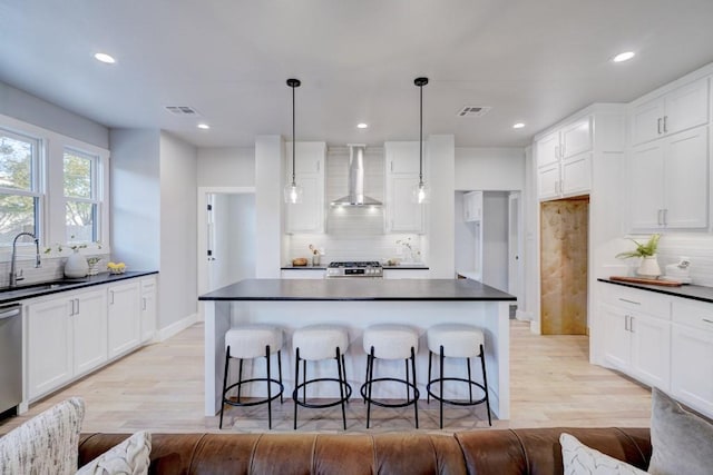 108 NW 25th St, Oklahoma City, OK 73103 - kitchen with a sink, wall chimney exhaust hood, dark countertops, and recessed lighting
