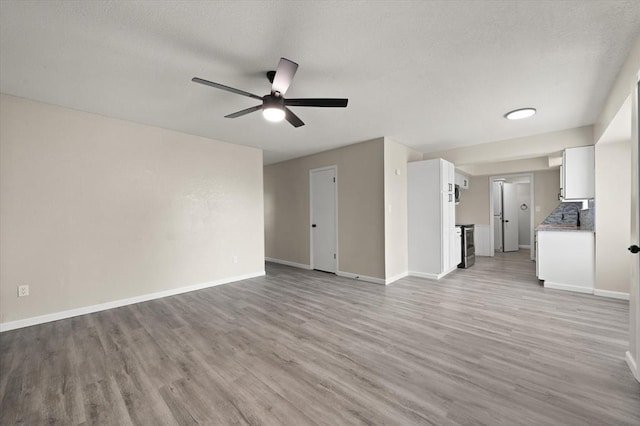 7 Concord Blvd, Shawnee, OK 74804 - unfurnished living room featuring light wood-type flooring, ceiling fan, and baseboards