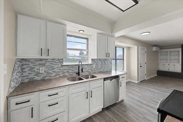 7 Concord Blvd, Shawnee, OK 74804 - kitchen with stainless steel dishwasher, a sink, electric stove, backsplash, and white cabinetry