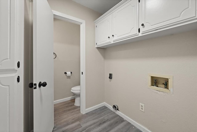 7 Concord Blvd, Shawnee, OK 74804 - washroom with light wood-type flooring, washer hookup, baseboards, hookup for an electric dryer, and cabinet space