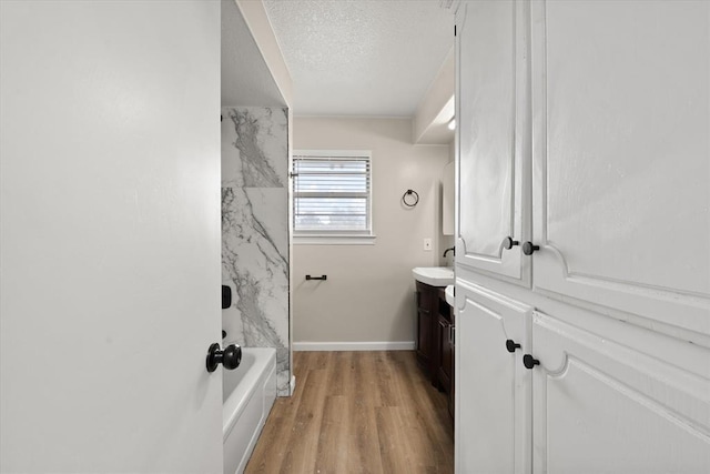 7 Concord Blvd, Shawnee, OK 74804 - full bathroom with vanity, a textured ceiling, wood finished floors, and baseboards