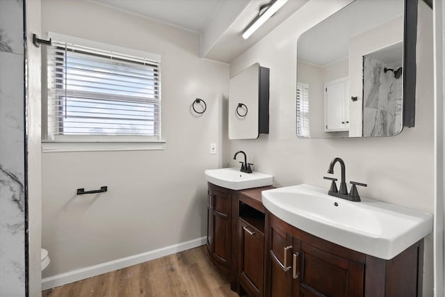 7 Concord Blvd, Shawnee, OK 74804 - full bathroom featuring wood finished floors, two vanities, baseboards, and a shower