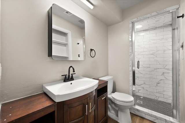 7 Concord Blvd, Shawnee, OK 74804 - bathroom featuring toilet, a stall shower, vanity, and wood finished floors