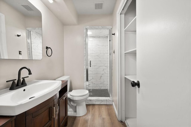 7 Concord Blvd, Shawnee, OK 74804 - bathroom with toilet, a shower stall, wood finished floors, and vanity
