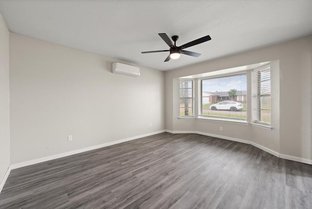 7 Concord Blvd, Shawnee, OK 74804 - unfurnished room with a wall unit AC, dark wood-type flooring, and baseboards