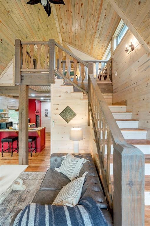 21 Sherwood Forest Ln, Broken Bow, OK 74728 - stairway with wooden walls, wood finished floors, high vaulted ceiling, a ceiling fan, and wood ceiling