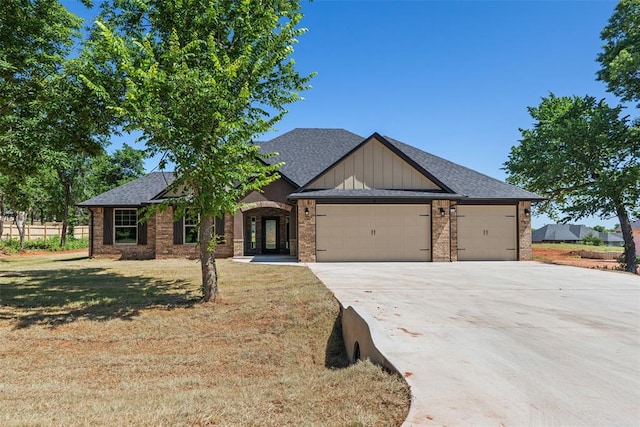 2414 Black Jack Way, Blanchard, OK 73010 - view of front facade featuring a garage, concrete driveway, a shingled roof, a front yard, and brick siding