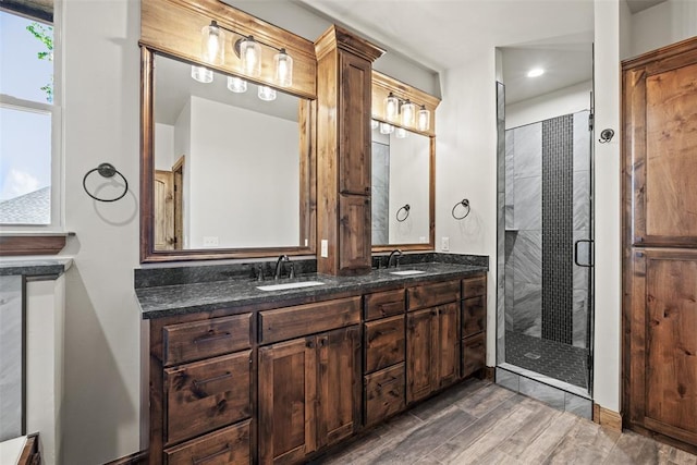 2414 Black Jack Way, Blanchard, OK 73010 - bathroom featuring double vanity, a stall shower, and wood finished floors