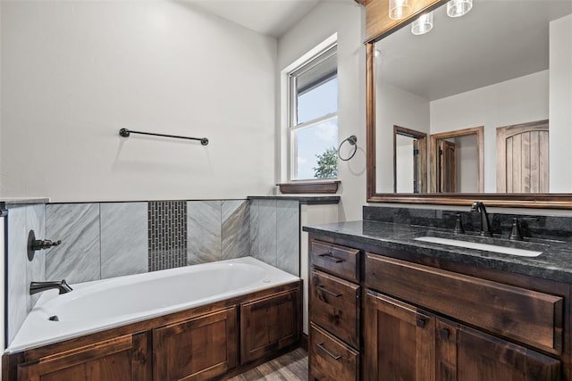2414 Black Jack Way, Blanchard, OK 73010 - full bath with vanity, a garden tub, and wood finished floors