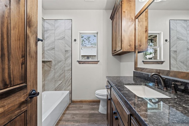 2414 Black Jack Way, Blanchard, OK 73010 - full bathroom with vanity, toilet, wood finished floors, baseboards, and  shower combination