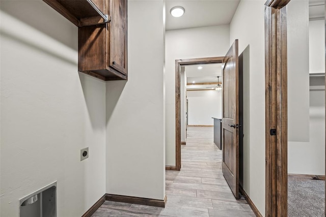2414 Black Jack Way, Blanchard, OK 73010 - laundry area with cabinet space, hookup for an electric dryer, light wood-style floors, and baseboards
