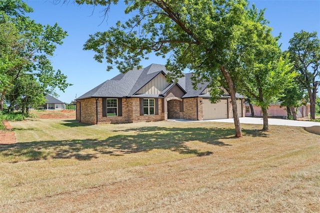 2414 Black Jack Way, Blanchard, OK 73010 - view of front of home featuring driveway, a front yard, brick siding, and board and batten siding