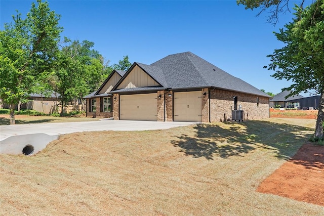 2414 Black Jack Way, Blanchard, OK 73010 - view of front of property with concrete driveway, brick siding, a garage, central AC, and a shingled roof