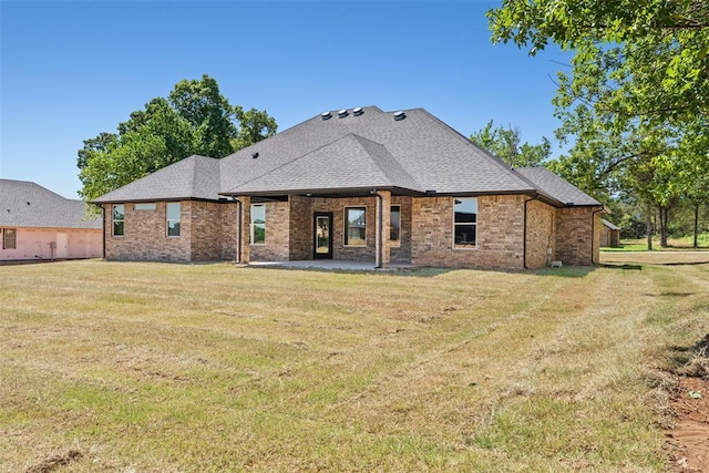 2414 Black Jack Way, Blanchard, OK 73010 - back of property with brick siding, a yard, a patio, and roof with shingles