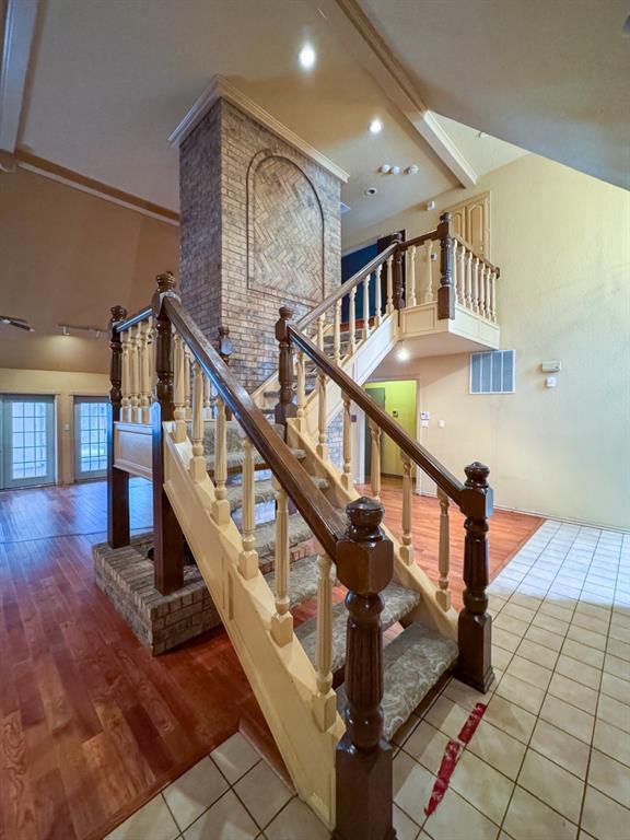 2010 Saddleback Blvd, Norman, OK 73072 - staircase featuring a towering ceiling, tile patterned flooring, and recessed lighting