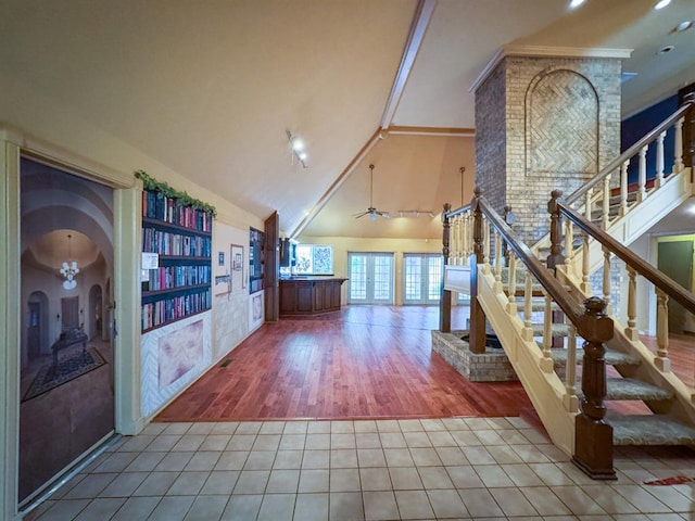 2010 Saddleback Blvd, Norman, OK 73072 - hallway with high vaulted ceiling, tile patterned floors, stairway, french doors, and arched walkways