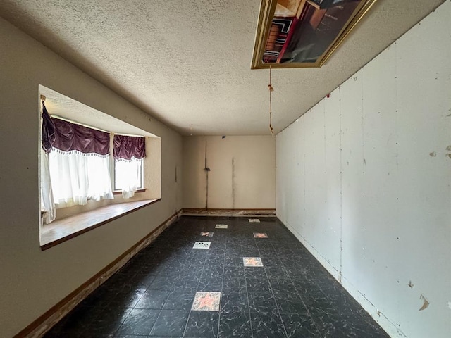 2010 Saddleback Blvd, Norman, OK 73072 - spare room featuring a textured ceiling and tile patterned floors