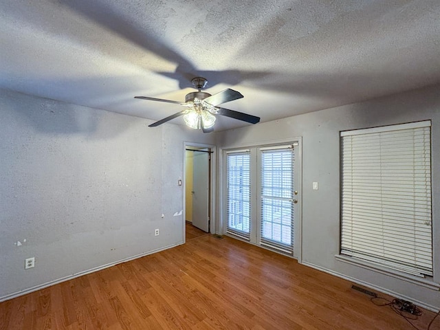 2010 Saddleback Blvd, Norman, OK 73072 - spare room with light wood-type flooring, ceiling fan, and a textured ceiling