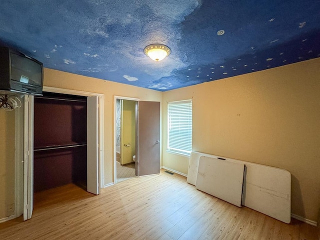 2010 Saddleback Blvd, Norman, OK 73072 - unfurnished bedroom featuring wood finished floors and baseboards
