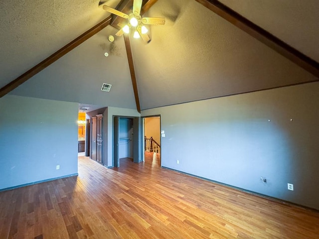 2010 Saddleback Blvd, Norman, OK 73072 - unfurnished room featuring beam ceiling, a ceiling fan, wood finished floors, high vaulted ceiling, and a textured ceiling
