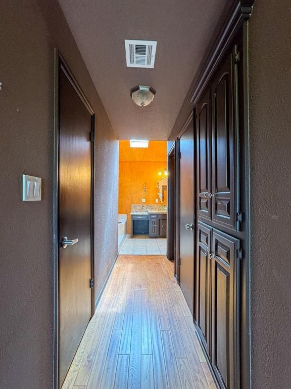2010 Saddleback Blvd, Norman, OK 73072 - hall with a textured wall and light wood finished floors