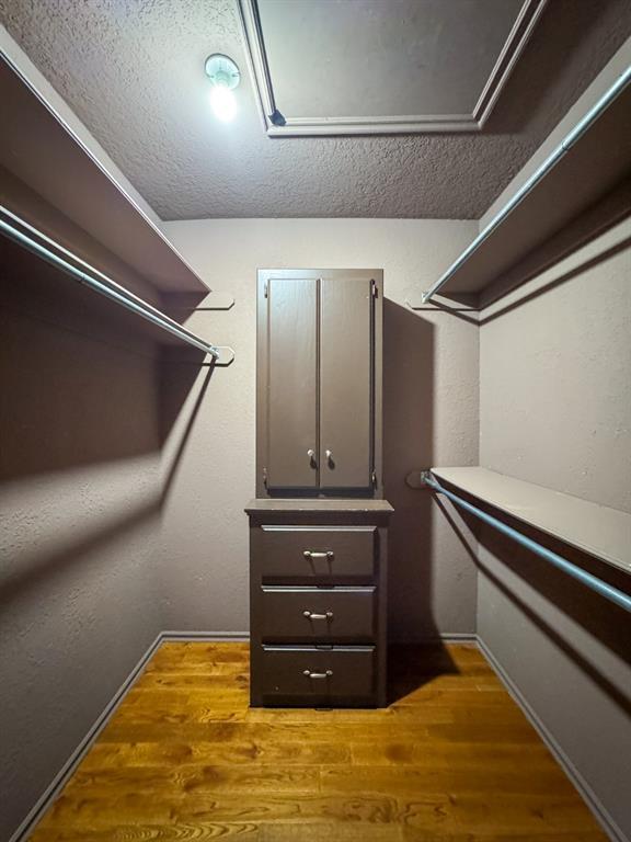 2010 Saddleback Blvd, Norman, OK 73072 - walk in closet with wood finished floors and attic access