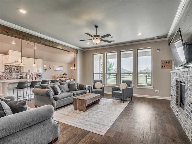 16112 Buffalo Dr, Oklahoma City, OK 73170 - living room with ornamental molding, a fireplace, dark wood finished floors, a ceiling fan, and baseboards