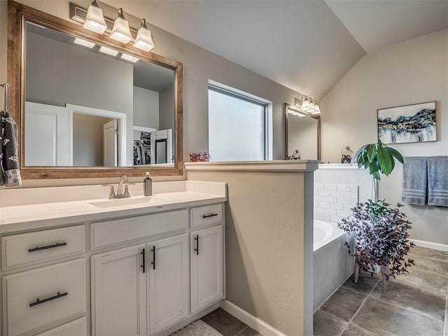 16112 Buffalo Dr, Oklahoma City, OK 73170 - bathroom featuring vaulted ceiling, a bath, vanity, and baseboards