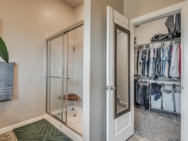 16112 Buffalo Dr, Oklahoma City, OK 73170 - bathroom with a stall shower, a walk in closet, and baseboards