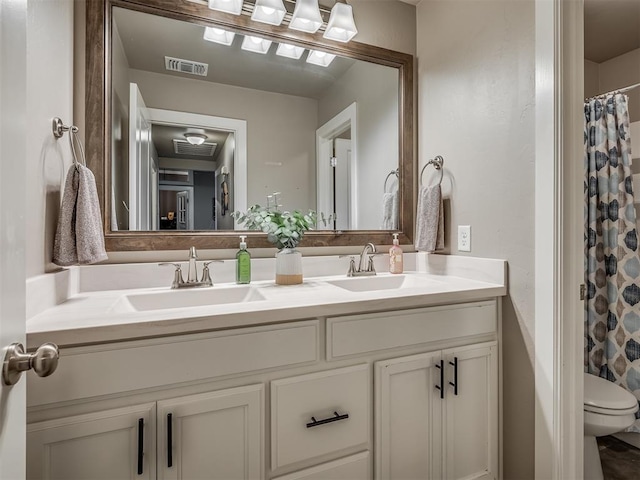 16112 Buffalo Dr, Oklahoma City, OK 73170 - bathroom with double vanity, toilet, and a shower with curtain