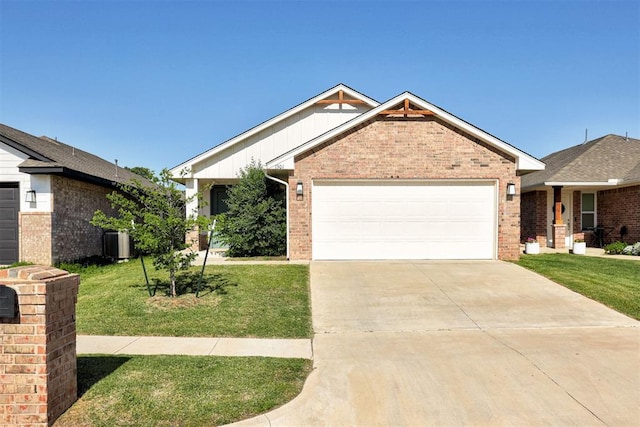 1301 Harvest Trl, Yukon, OK 73099 - view of front of home with brick siding, an attached garage, a front lawn, and driveway