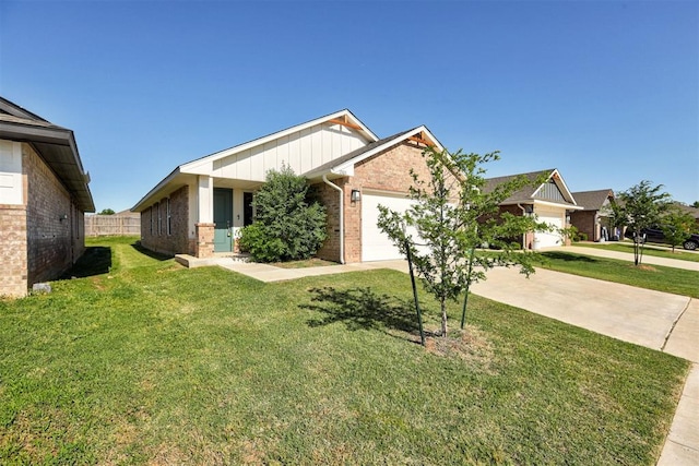 1301 Harvest Trl, Yukon, OK 73099 - view of front of home featuring brick siding, an attached garage, a front lawn, and concrete driveway