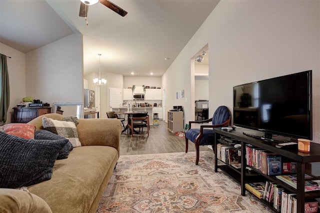 1301 Harvest Trl, Yukon, OK 73099 - living area featuring ceiling fan, light wood-style floors, a chandelier, and lofted ceiling