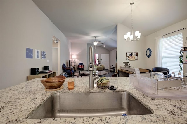 1301 Harvest Trl, Yukon, OK 73099 - kitchen with vaulted ceiling, light stone countertops, ceiling fan, hanging light fixtures, and a sink