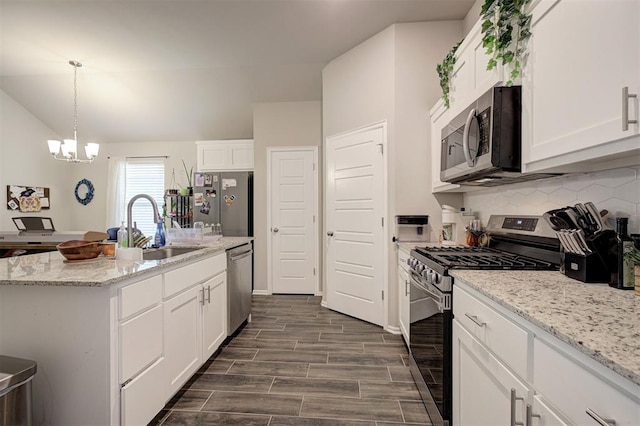 1301 Harvest Trl, Yukon, OK 73099 - kitchen with appliances with stainless steel finishes, a sink, decorative backsplash, white cabinets, and lofted ceiling