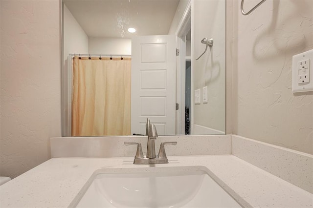1301 Harvest Trl, Yukon, OK 73099 - bathroom with a textured wall, vanity, and curtained shower