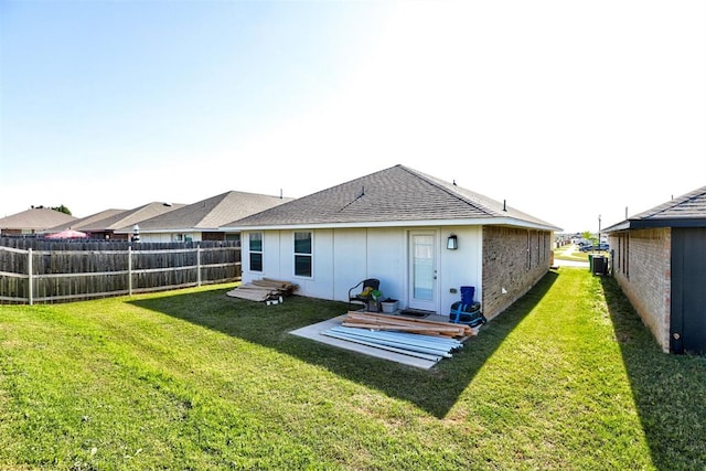 1301 Harvest Trl, Yukon, OK 73099 - rear view of property featuring roof with shingles, central air condition unit, and brick siding