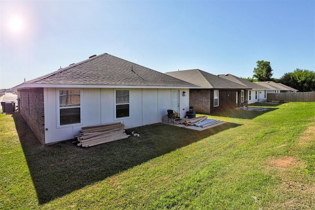 1301 Harvest Trl, Yukon, OK 73099 - rear view of property featuring central AC, roof with shingles, and board and batten siding