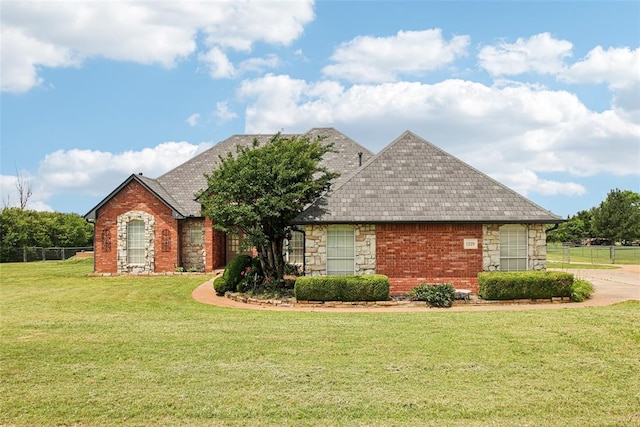 1329 S Southersby Dr, Mustang, OK 73064 - view of front facade with stone siding and a shingled roof