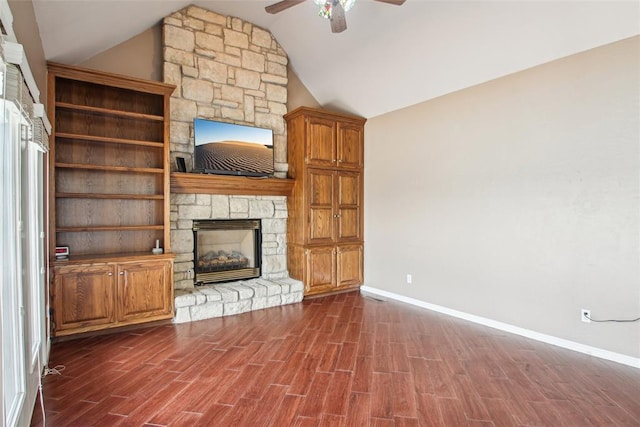 1329 S Southersby Dr, Mustang, OK 73064 - unfurnished living room featuring a stone fireplace, a ceiling fan, baseboards, dark wood finished floors, and lofted ceiling