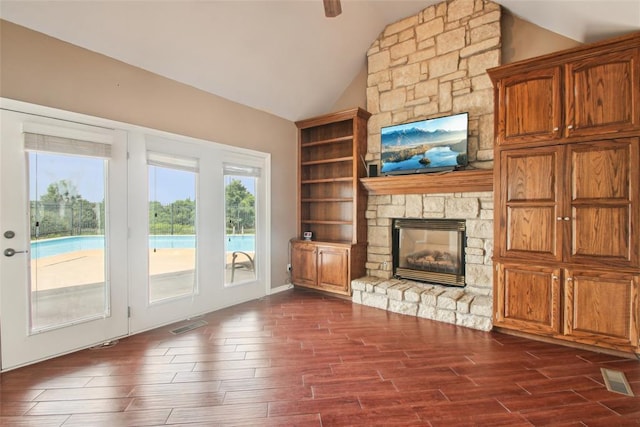 1329 S Southersby Dr, Mustang, OK 73064 - unfurnished living room with vaulted ceiling, dark wood-style floors, and a stone fireplace