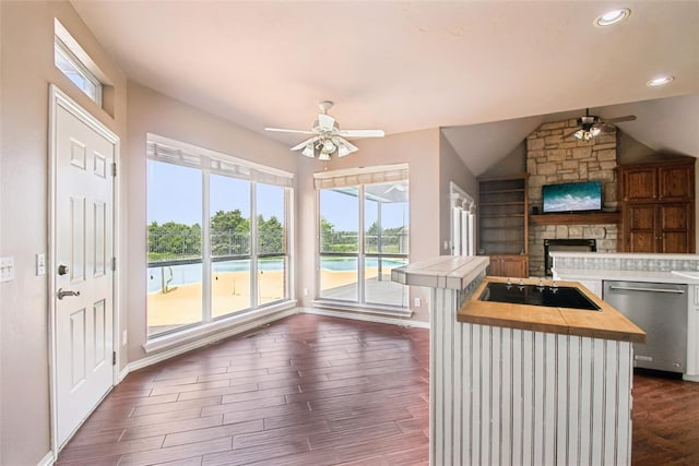 1329 S Southersby Dr, Mustang, OK 73064 - kitchen featuring a ceiling fan, stainless steel dishwasher, black electric stovetop, butcher block counters, and a fireplace