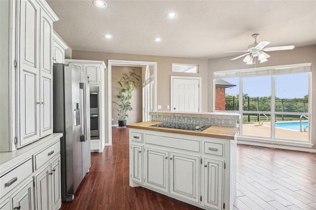 1329 S Southersby Dr, Mustang, OK 73064 - kitchen featuring stainless steel appliances, wood counters, a ceiling fan, dark wood-style flooring, and recessed lighting