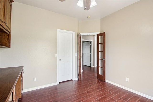 1329 S Southersby Dr, Mustang, OK 73064 - unfurnished room featuring dark wood finished floors, baseboards, and a ceiling fan