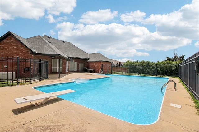1329 S Southersby Dr, Mustang, OK 73064 - view of swimming pool with a patio area and a diving board
