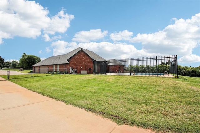 1329 S Southersby Dr, Mustang, OK 73064 - view of home's exterior featuring brick siding and a swimming pool